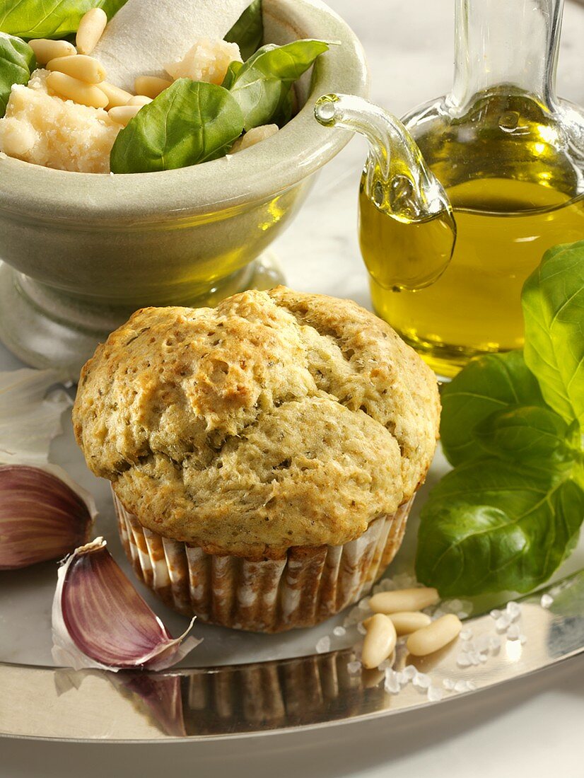 Parmesan and pesto muffin surrounded by ingredients