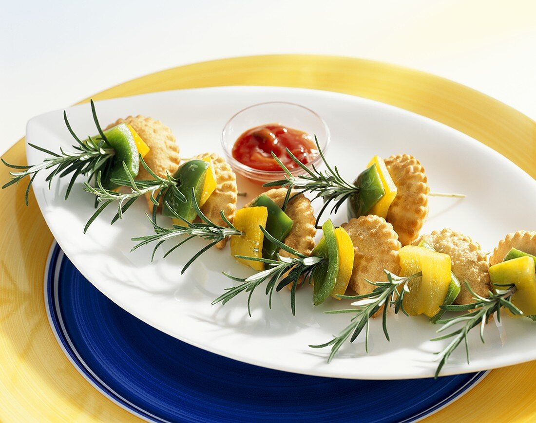 Small mascarpone pasties with peppers on rosemary skewers
