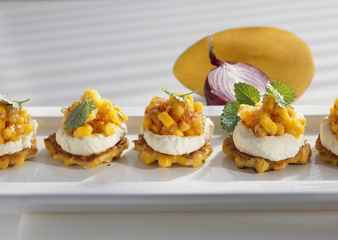 Corn cakes with cheese creme and mango salsa