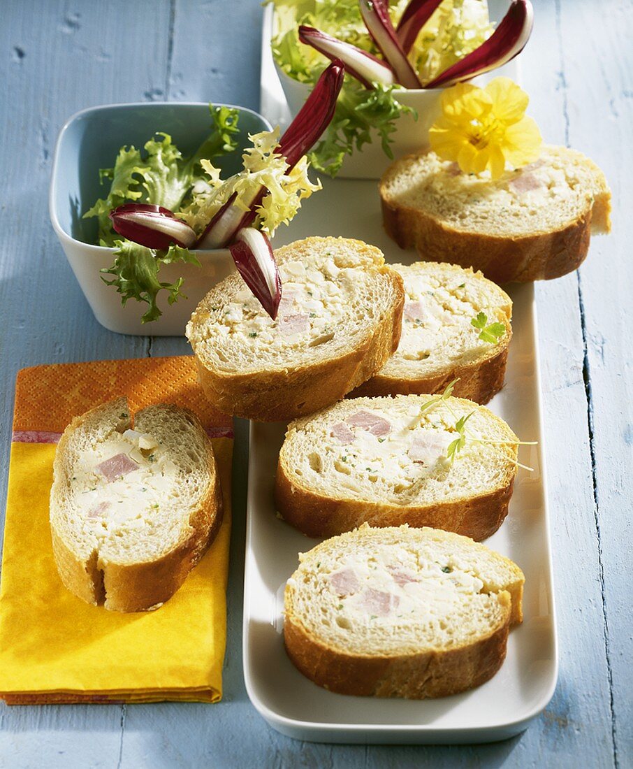 Stuffed baguette slices with soft cheese and ham filling