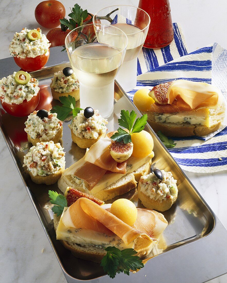Assorted appetisers and open sandwiches on tray