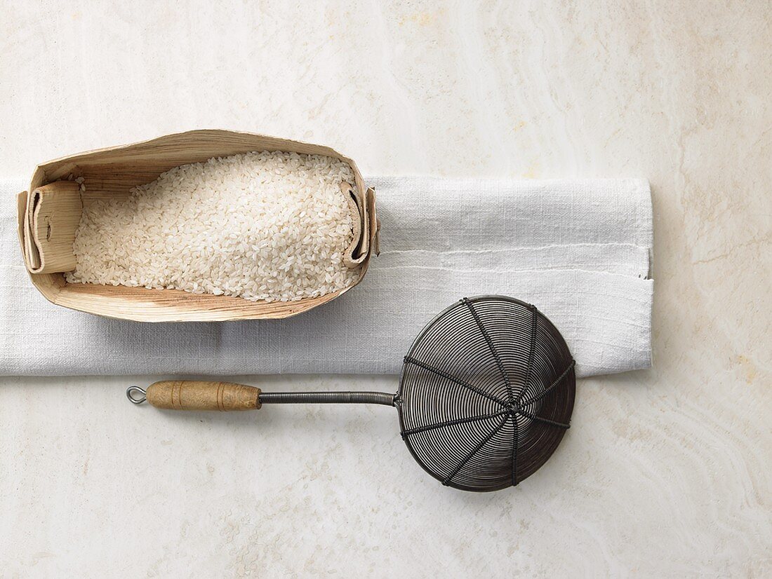 Rice in woodchip basket, straining spoon