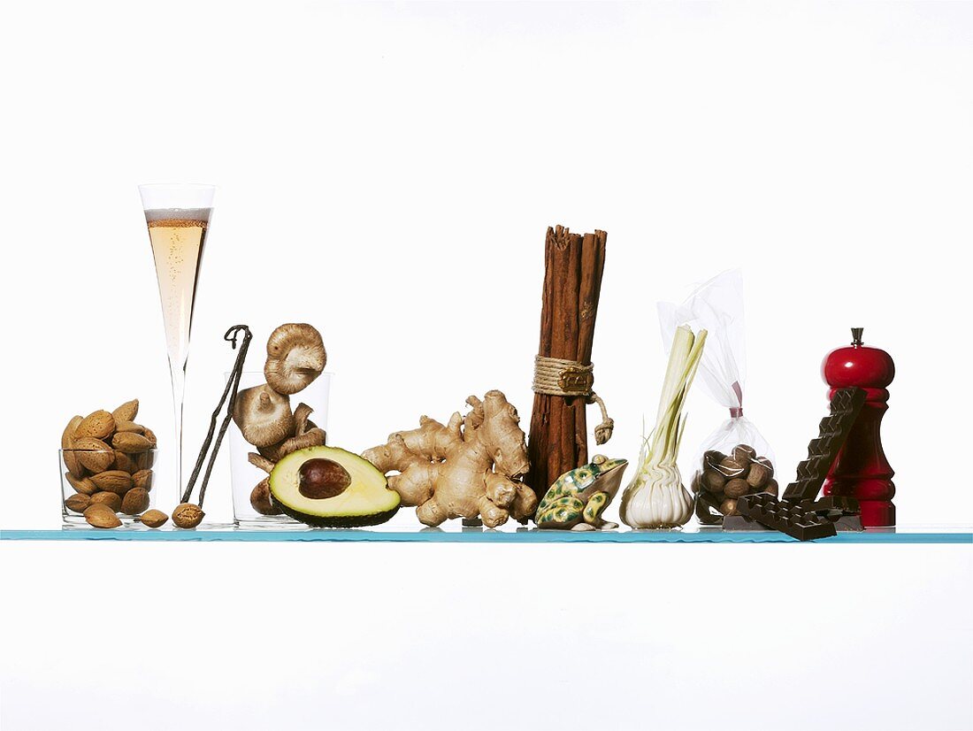 Still life: spices, avocado, almonds & glass of sparkling wine