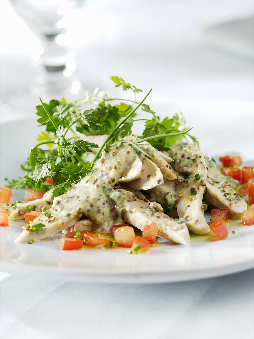 Poultry salad with mustard dressing and coriander leaves