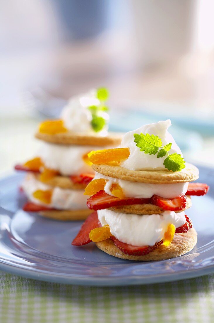 Towers of biscuits, cream, strawberries and peaches
