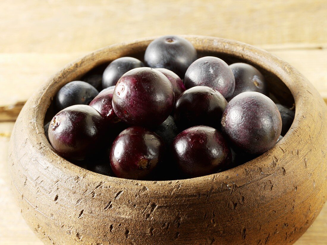 Acai berries in wooden bowl