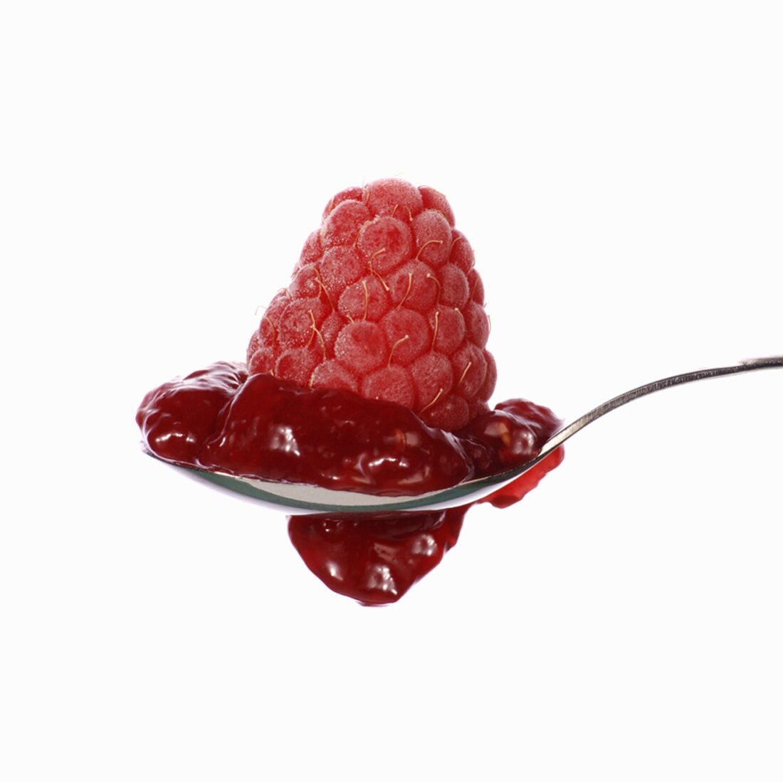 Raspberry jam and raspberry on spoon