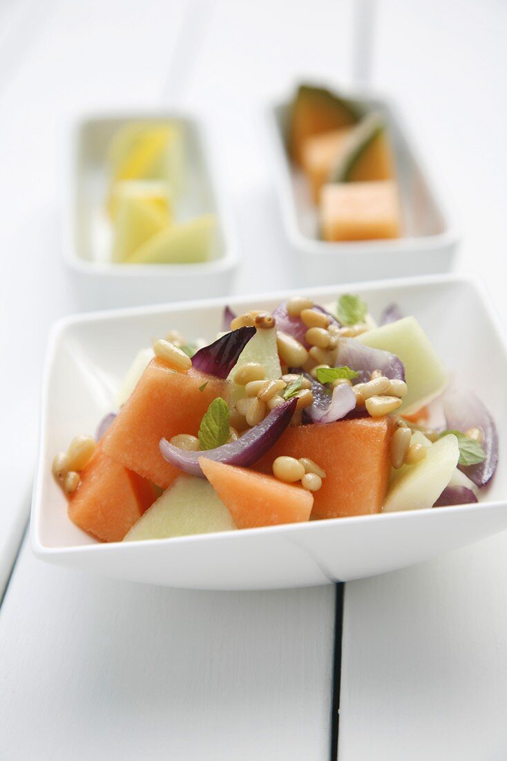 Melon salad with pine nuts and onions