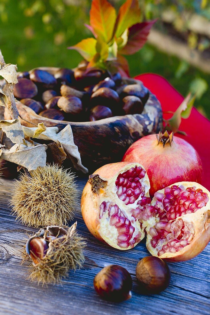 Pomegranates, sweet chestnuts and autumn leaves