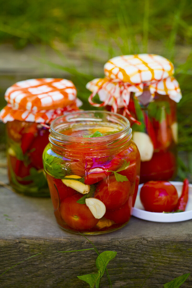 Pickled tomatoes in jars out of doors