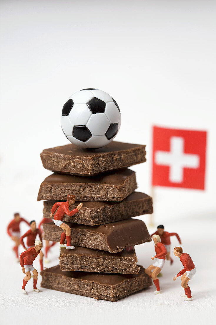 Pieces of chocolate, football, toy footballers, Swiss flag