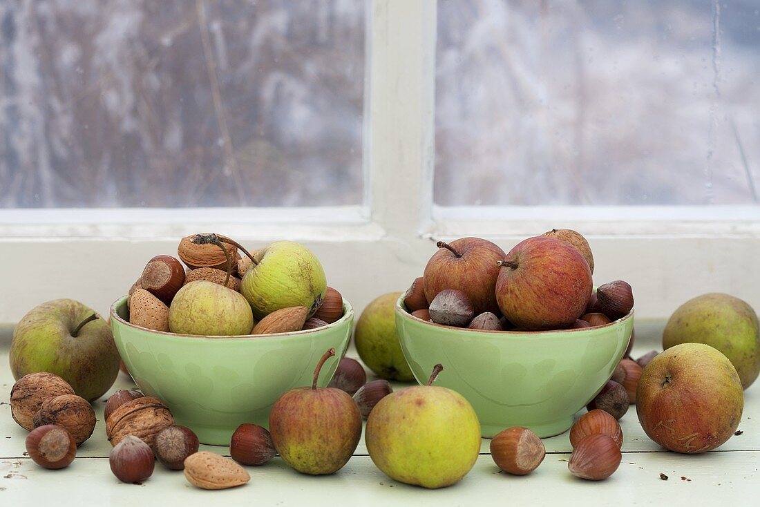 Apples, almonds and nuts on a windowsill