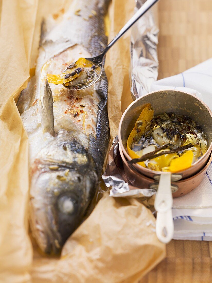 Sea bass in paper with fennel and lavender flowers