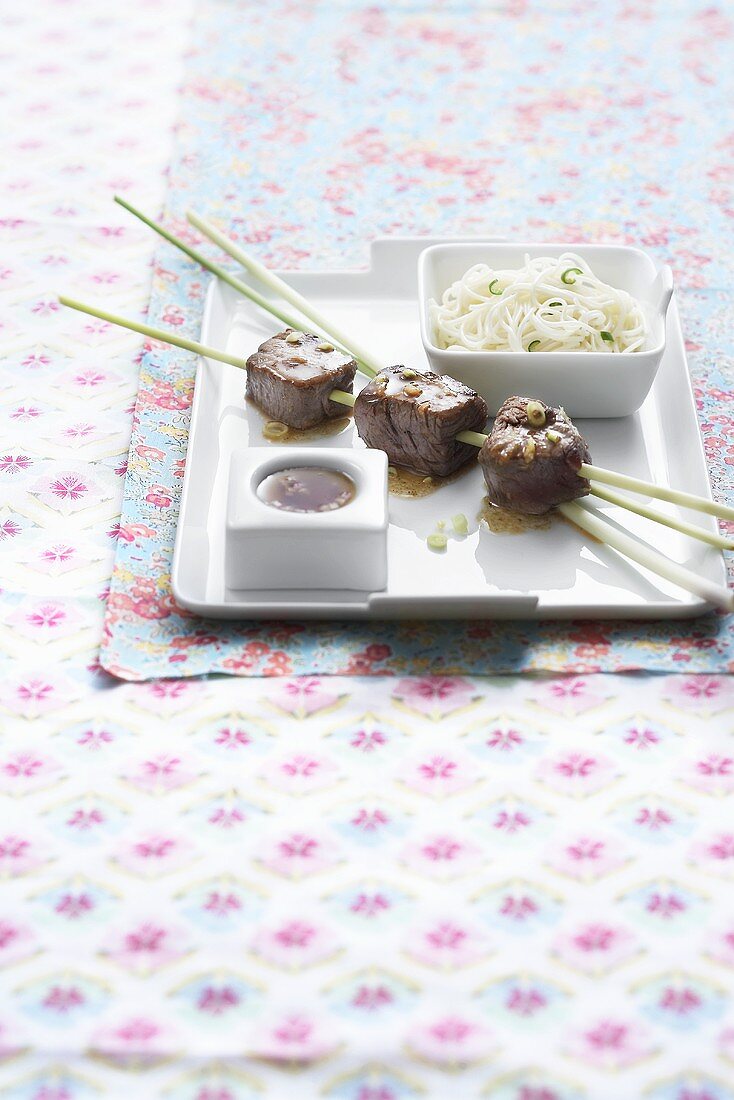 Oriental lemongrass and beef kebabs with noodles and a dip