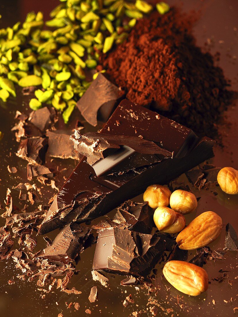 Pieces of chocolate, nuts and cocoa powder