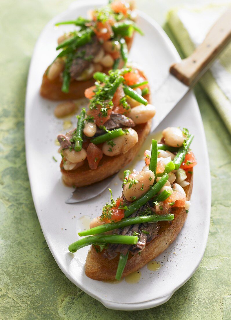 Baguette slices topped with bean salad