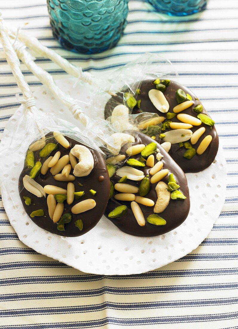 Chocolate lollies with pine nuts and pistachios