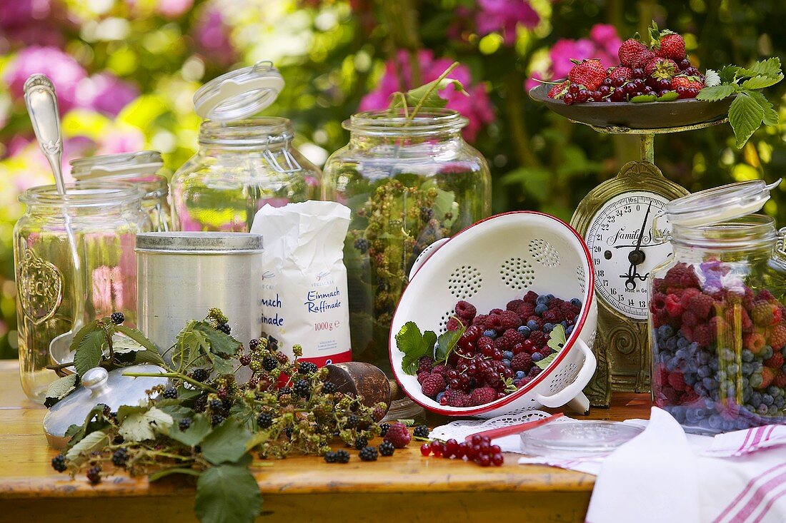 Still life with berries and preserving jars