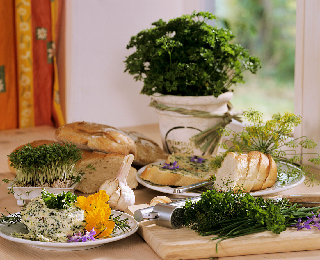 Still life with herb butter, fresh herbs and bread