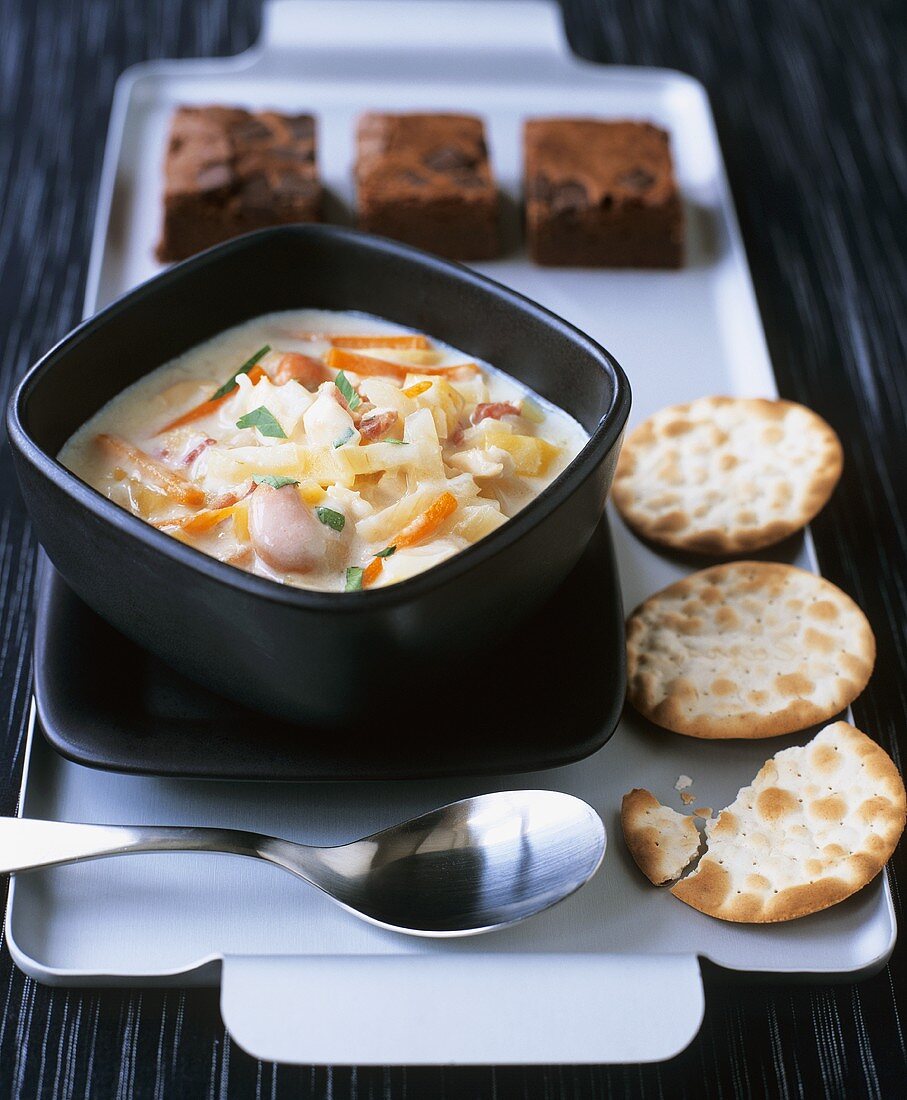Scallop and vegetable stew with crackers and brownies