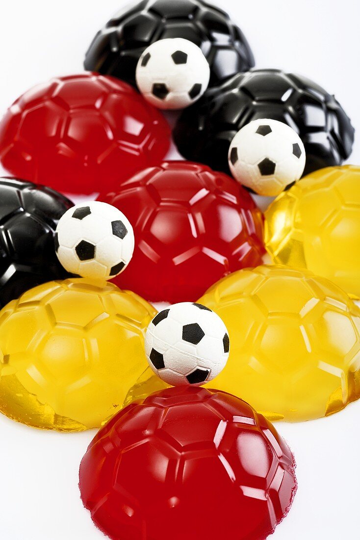 Black, red and yellow jellies in shape of footballs