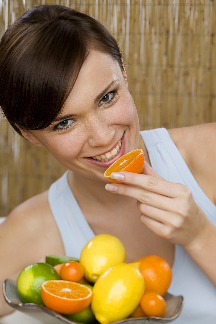 Young woman with citrus fruit