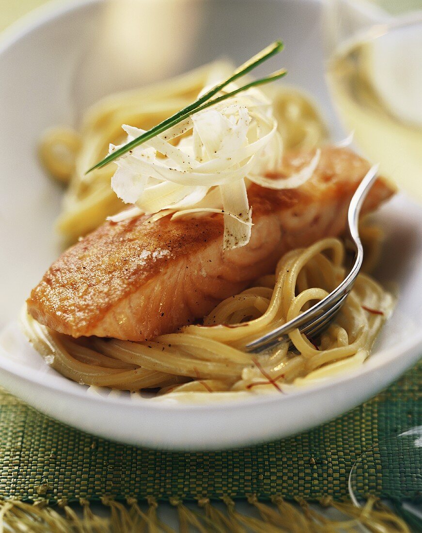 Fried salmon with horseradish on spaghetti