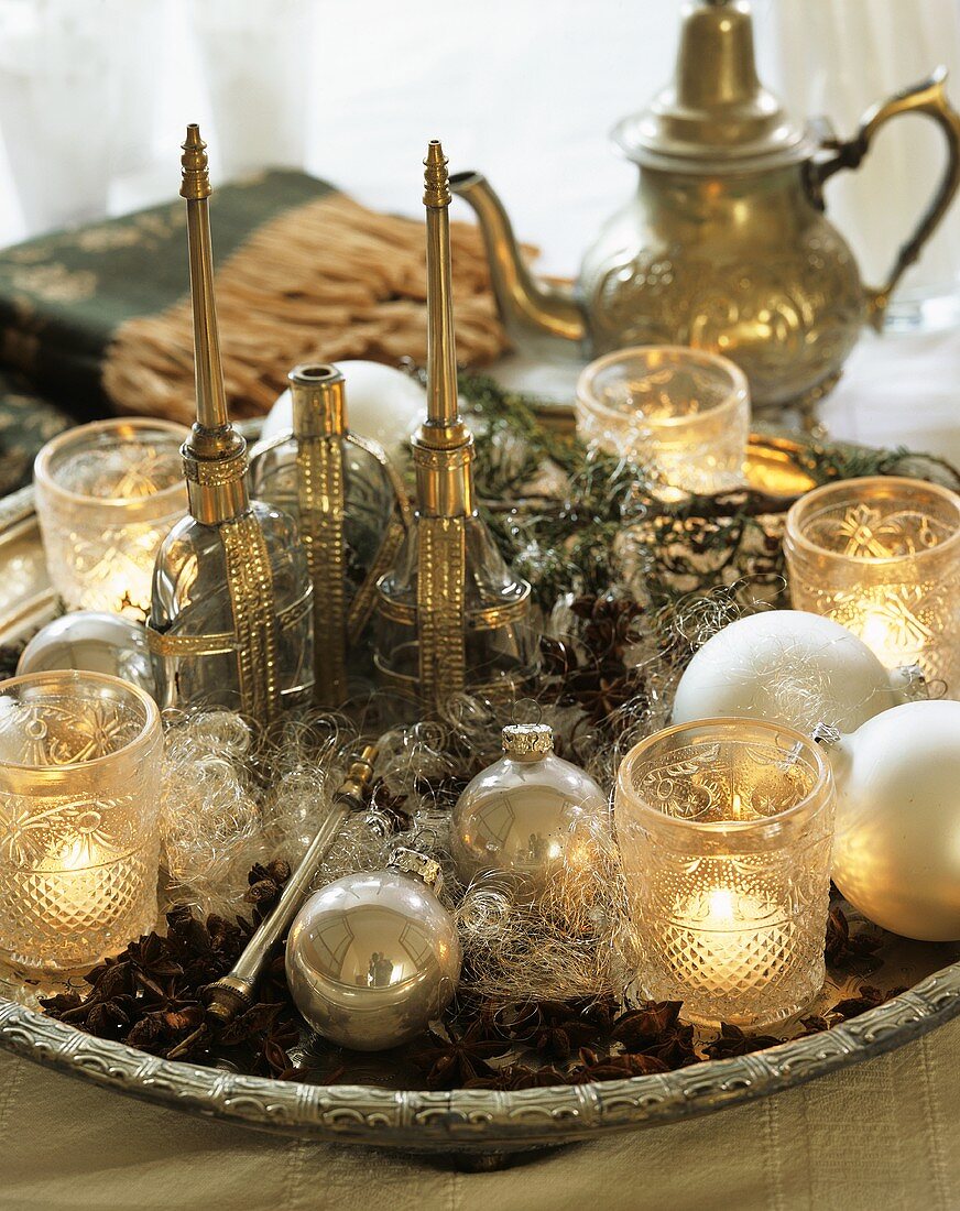 Middle Eastern plate with candles, baubles and glasses