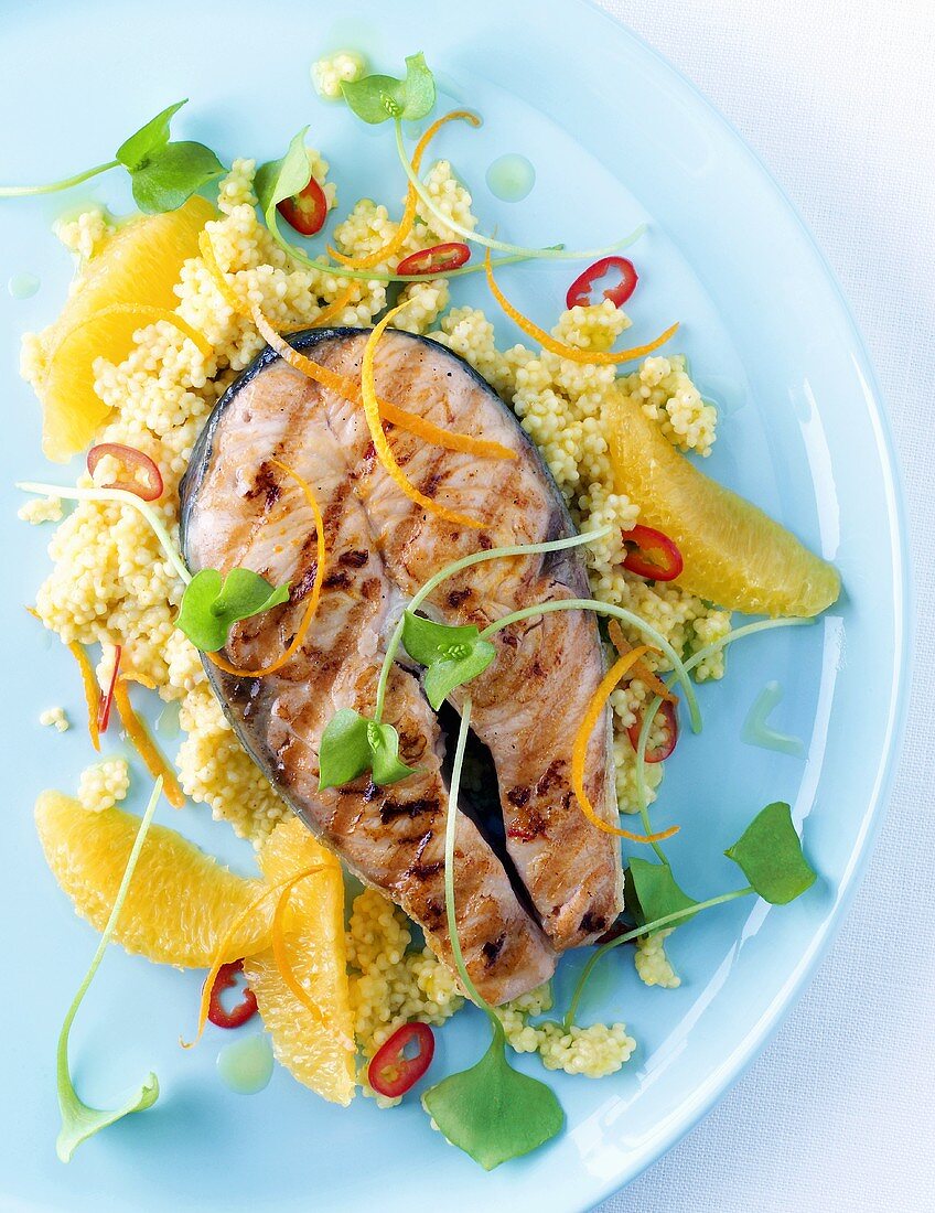 Marinated salmon cutlet on millet with oranges