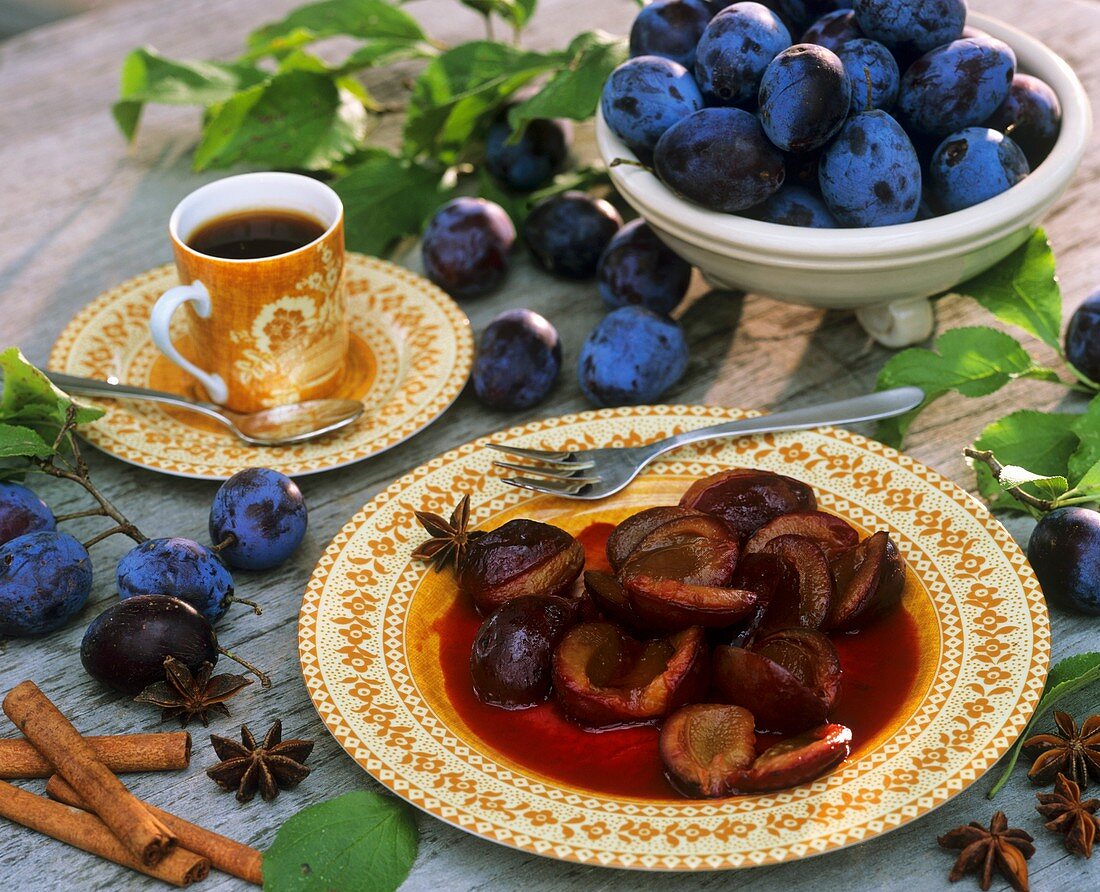 Plum compote, fresh plums and a cup of coffee