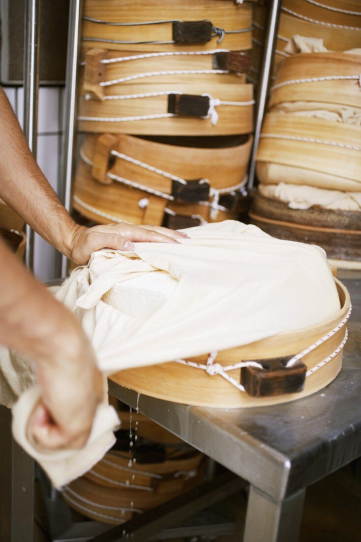 Putting cheese in round mould