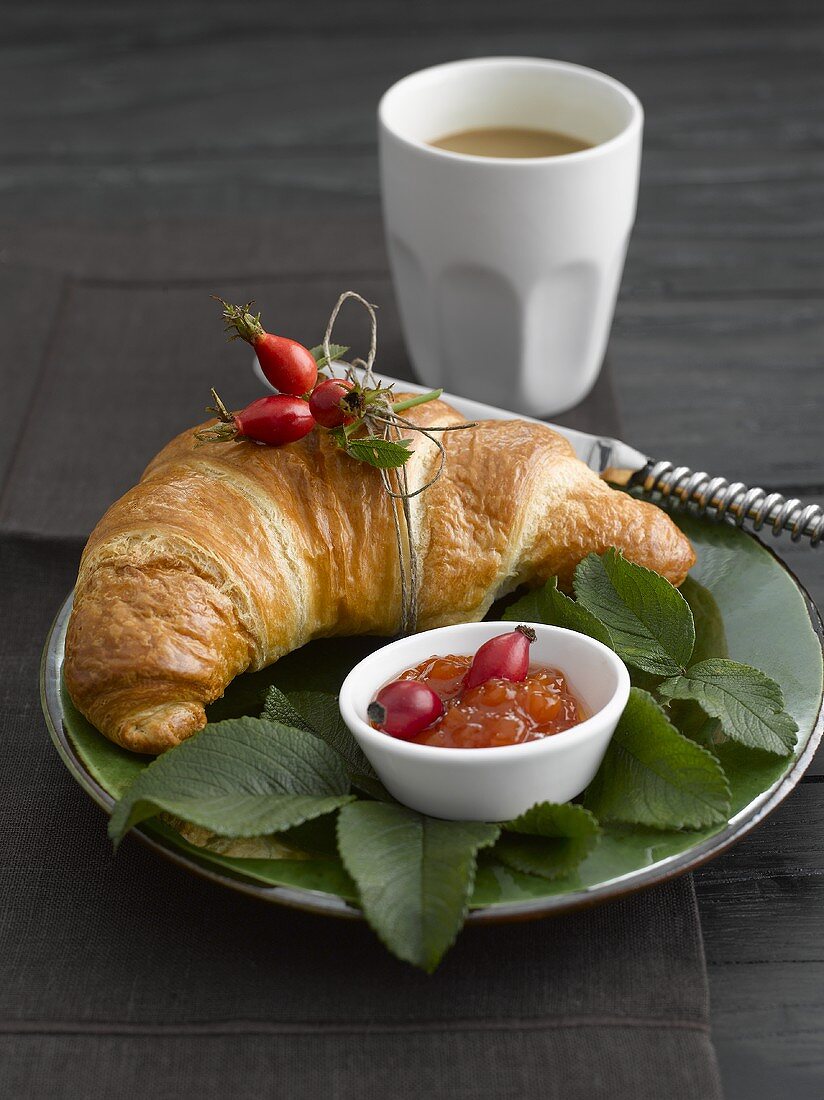 Croissant, rose hip jam and coffee for breakfast