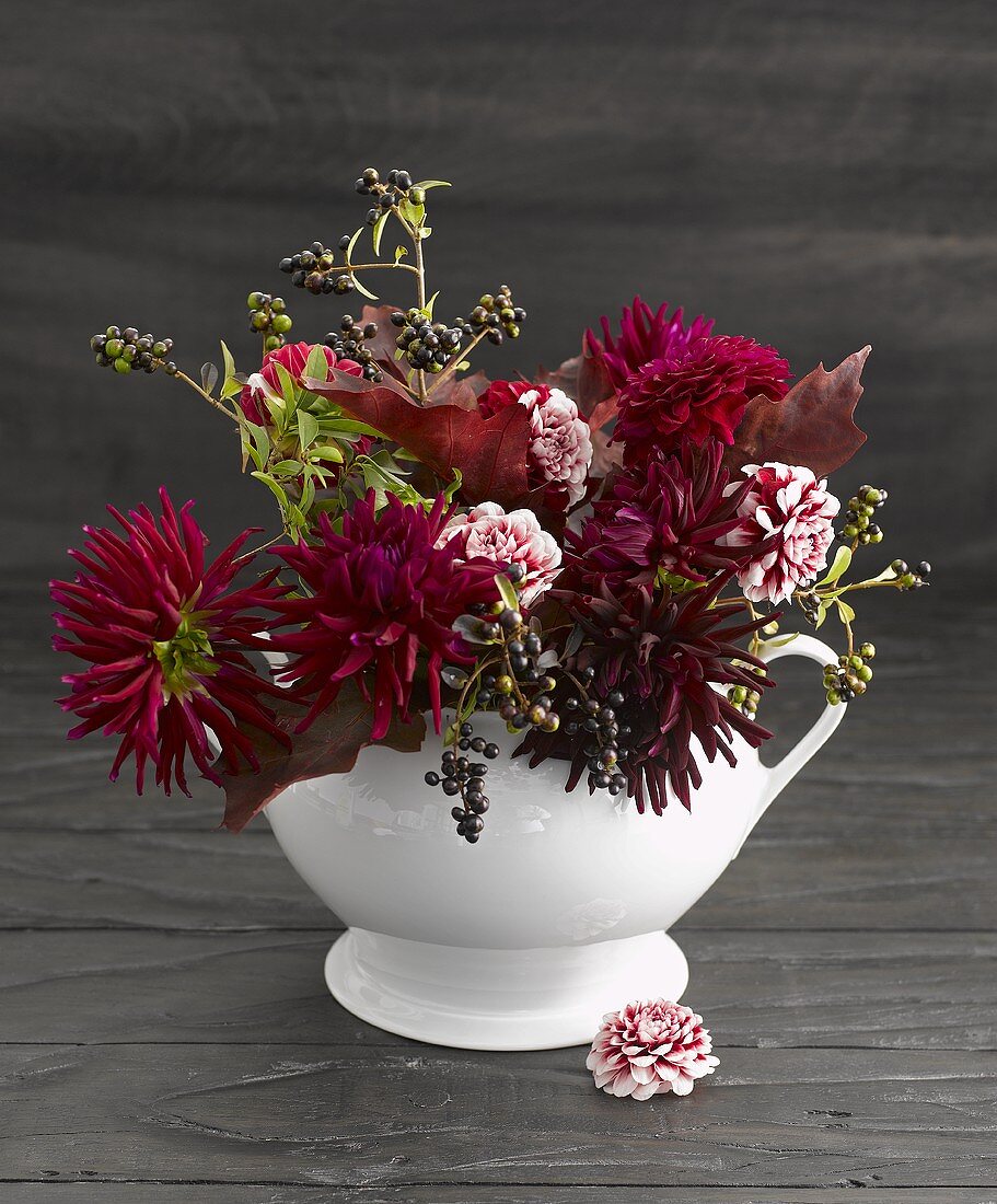 Autumnal flower arrangement in porcelain vase