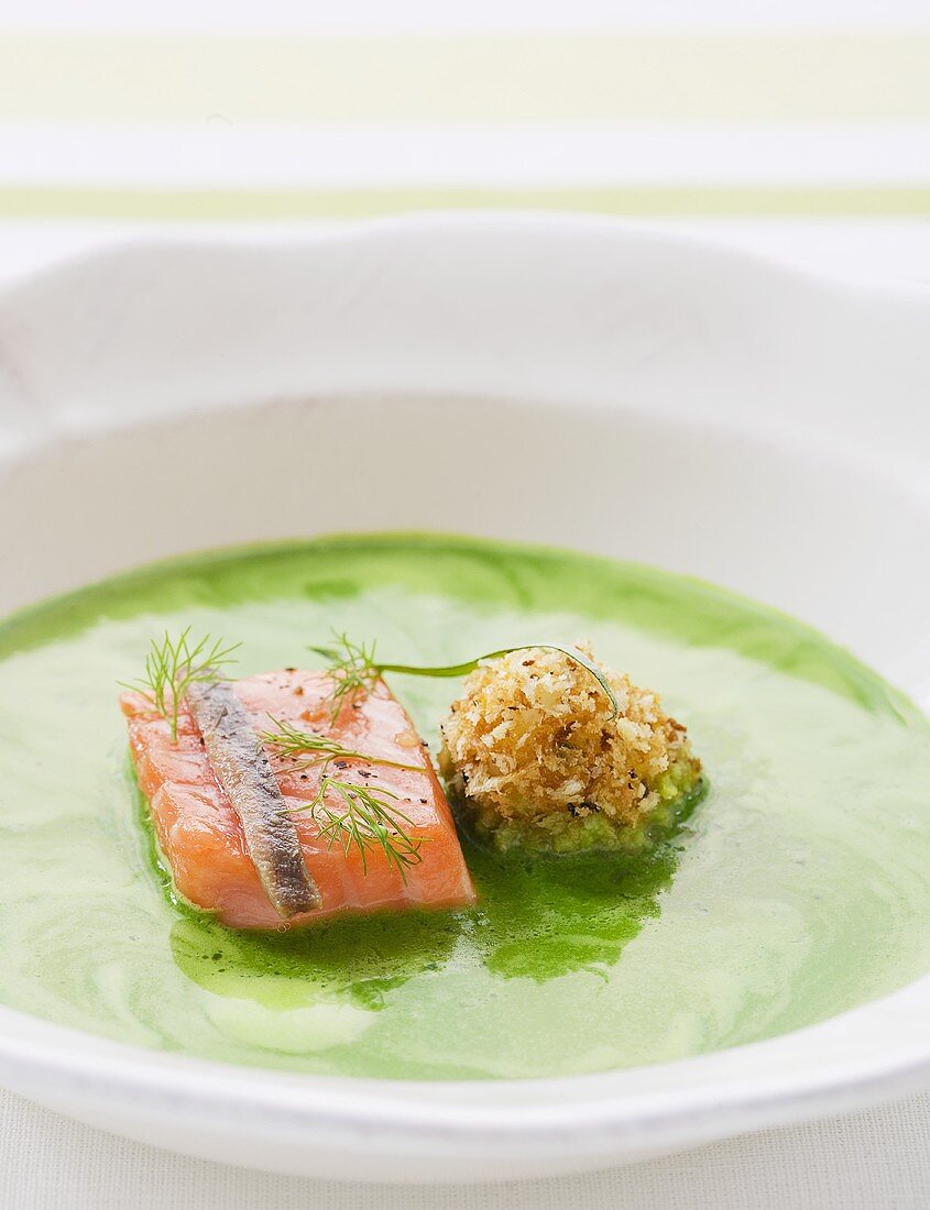 Herb soup with salmon and herring croquette