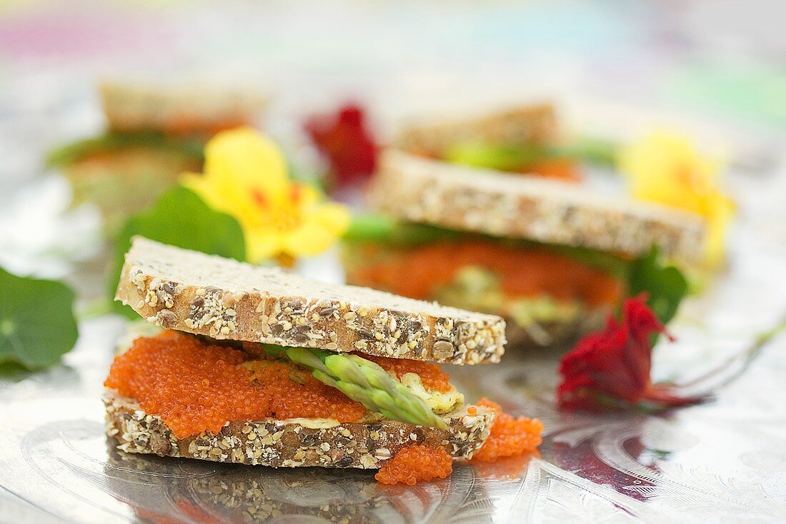 Caviar and asparagus sandwiches with nasturtium flowers