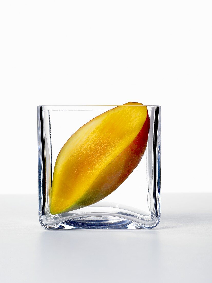 Half a mango in a glass dish