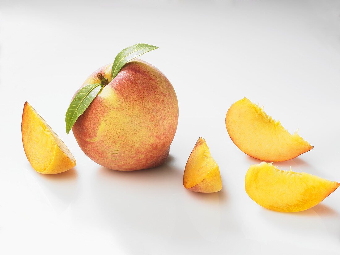 Whole peach and peach wedges