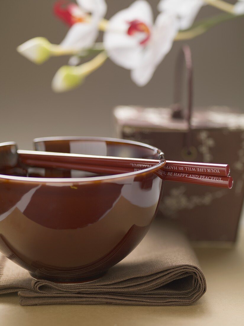 Asian place-setting (napkin, bowl and chopsticks)