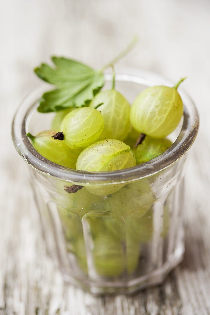 Green gooseberries in a glass