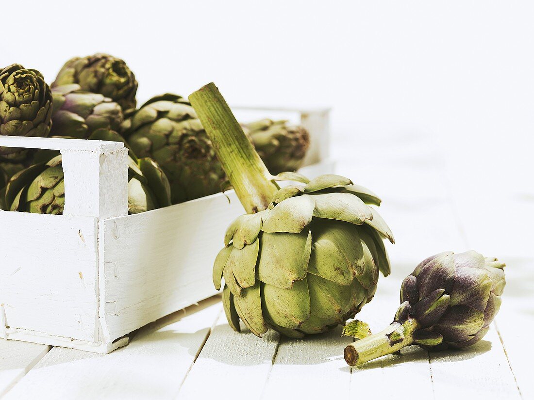 Artichokes in and beside crate