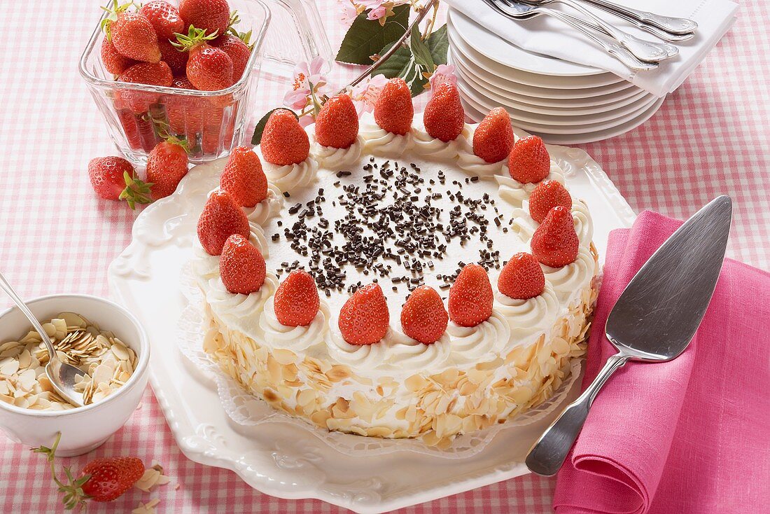 Strawberry cream cake with flaked almonds