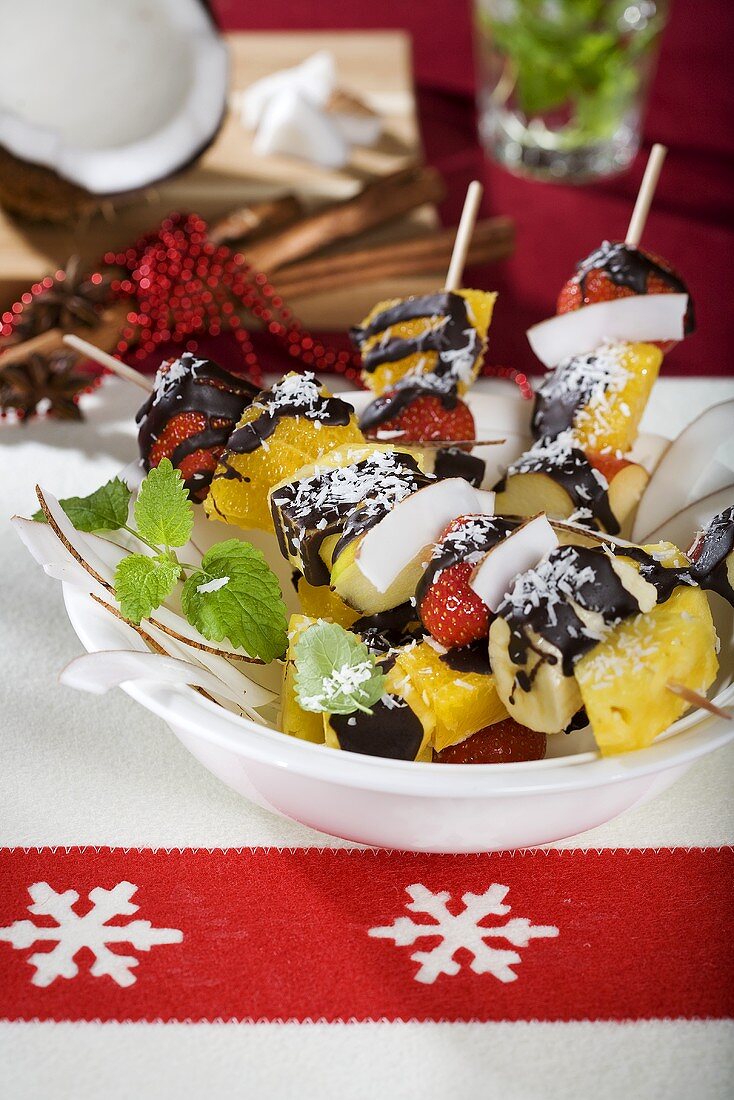 Exotic fruit skewers with coconut and chocolate