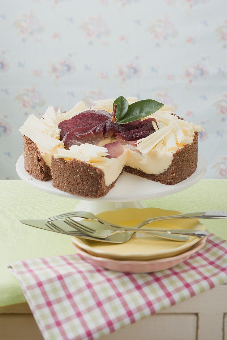 Cheesecake with red wine pears and white chocolate curls