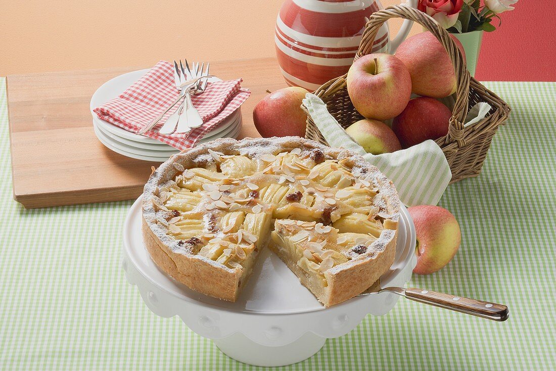 Apple tart with flaked almonds, a piece cut
