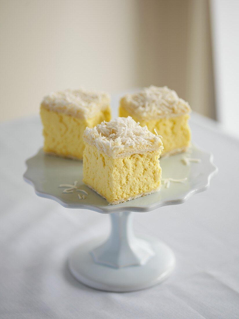 Vanilla and coconut squares on cake stand
