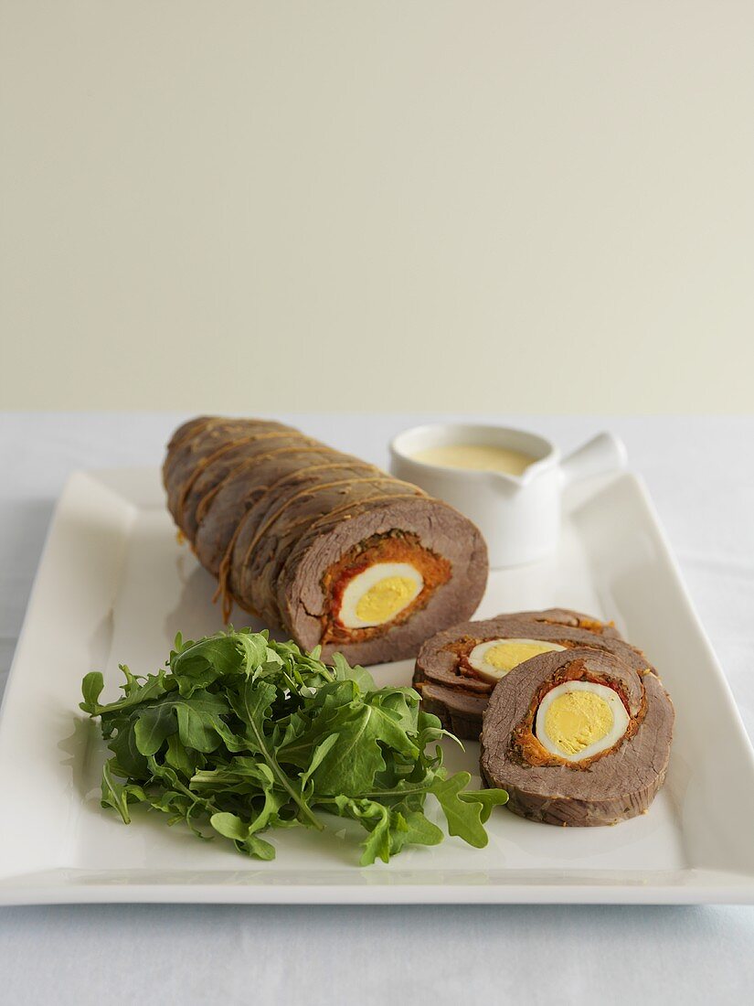 Beef roulade filled with egg, rocket salad