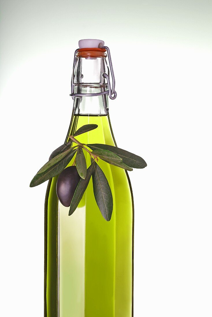 Bottle of olive oil with olive sprig
