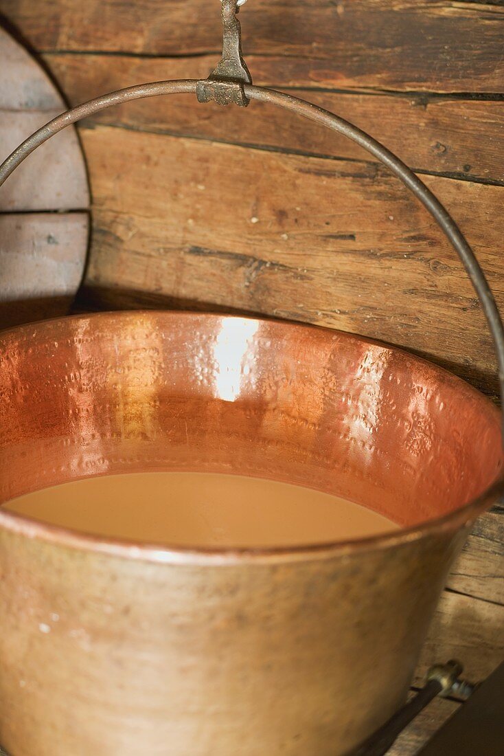 Milk in a copper cauldron in an Alpine chalet