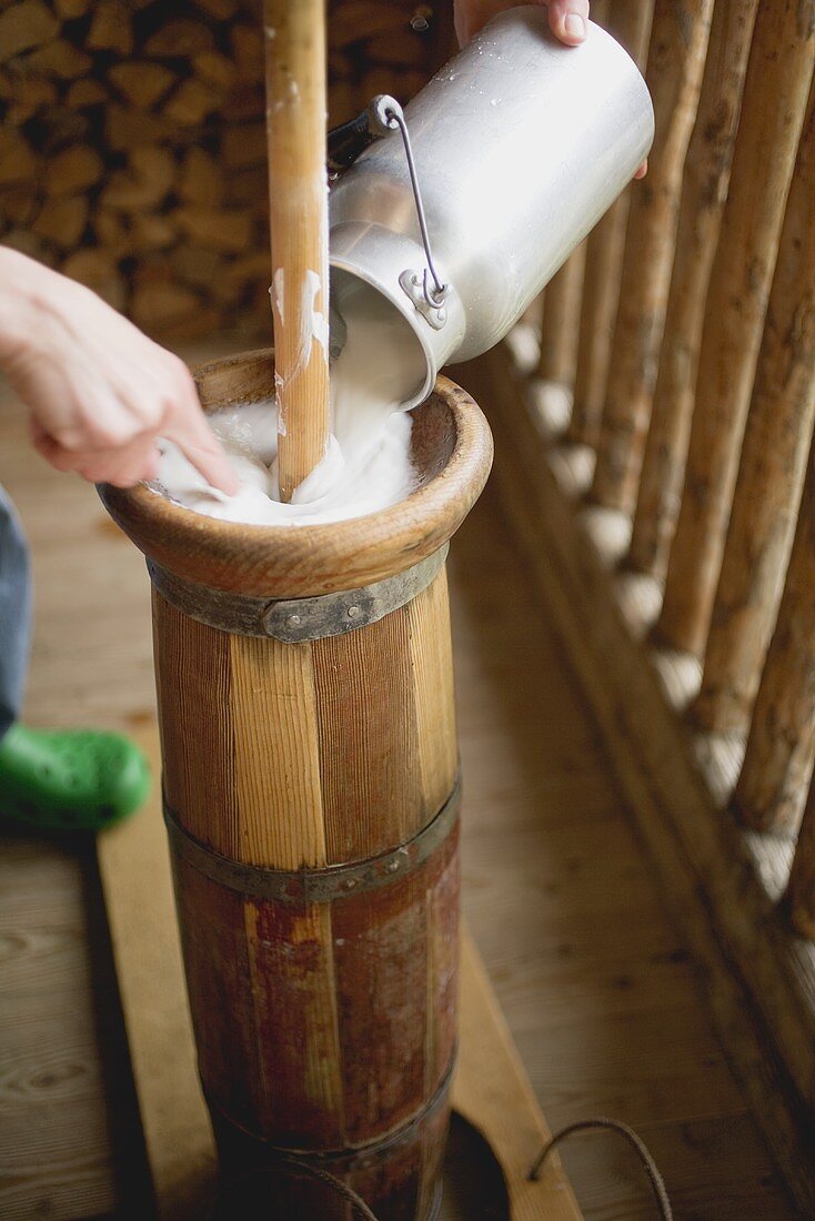 Pouring milk into a butter churn