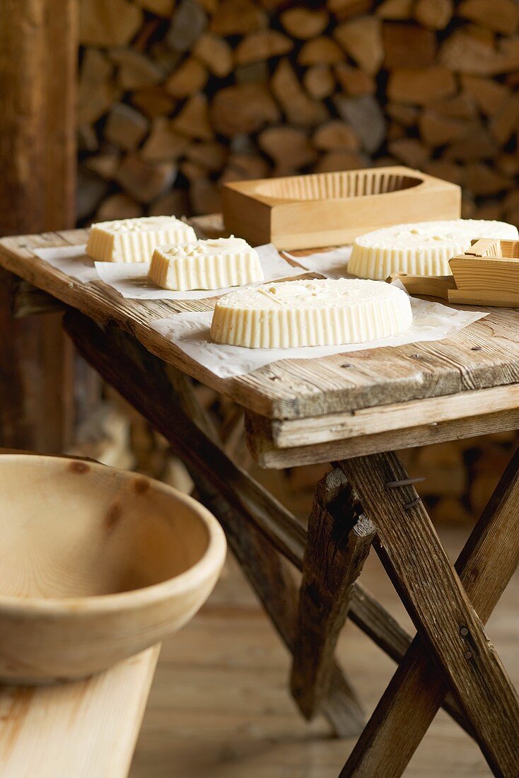 Farmhouse butter and various wooden moulds on wooden table